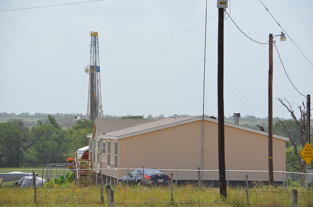 Coming soon to a yard near yours? A fracking well looms over a residence in the Eagle Ford shale region of Texas. (Photo by Earthworks Action/Flickr) 