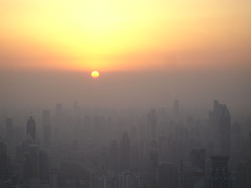 Sunset in Shanghai. Except that’s not the horizon the sun is sinking behind, it’s the pollution layer. (Photo By Suicup via Wikimedia Commons) 